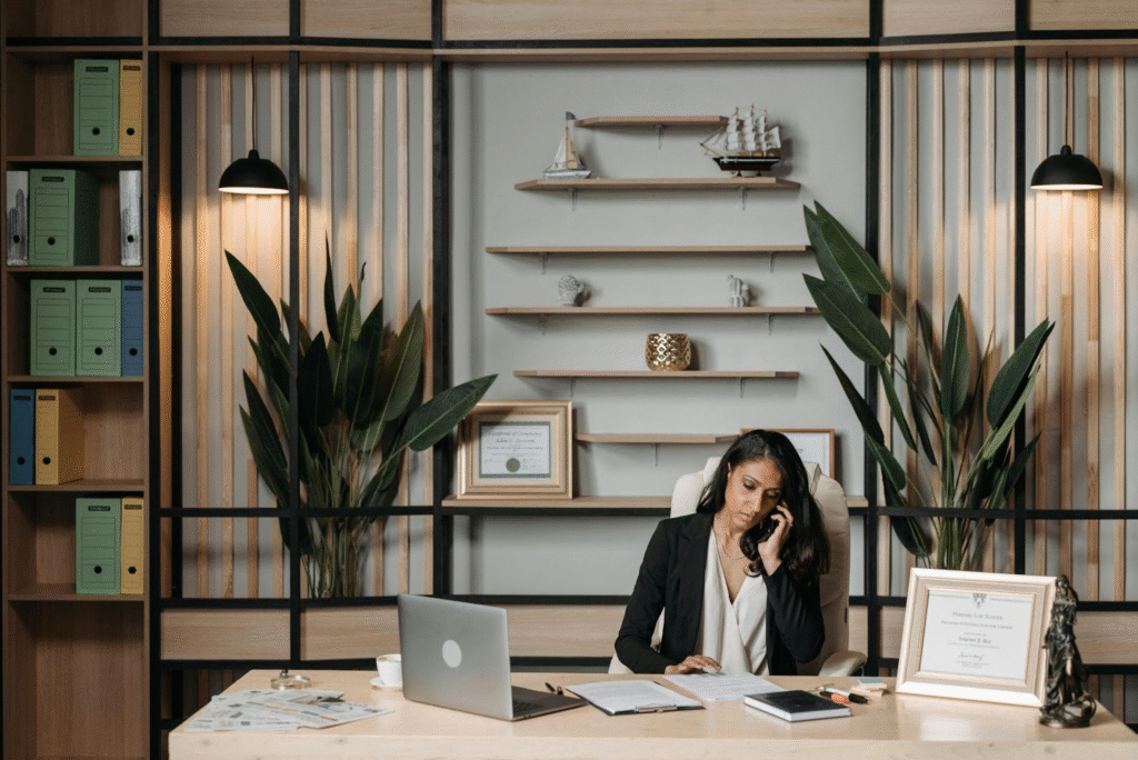 Personal injury lawyer reviewing legal documents and speaking with a client over the phone.
