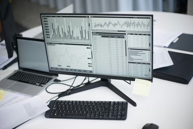 Desktop monitor displaying graphs and analytics dashboards for tracking digital marketing performance. 